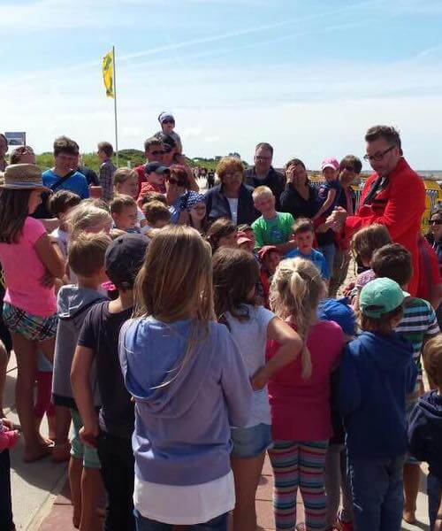 Magischer Walk Act auf der Strandpromenade. Zino umringt von vielen Kindern.